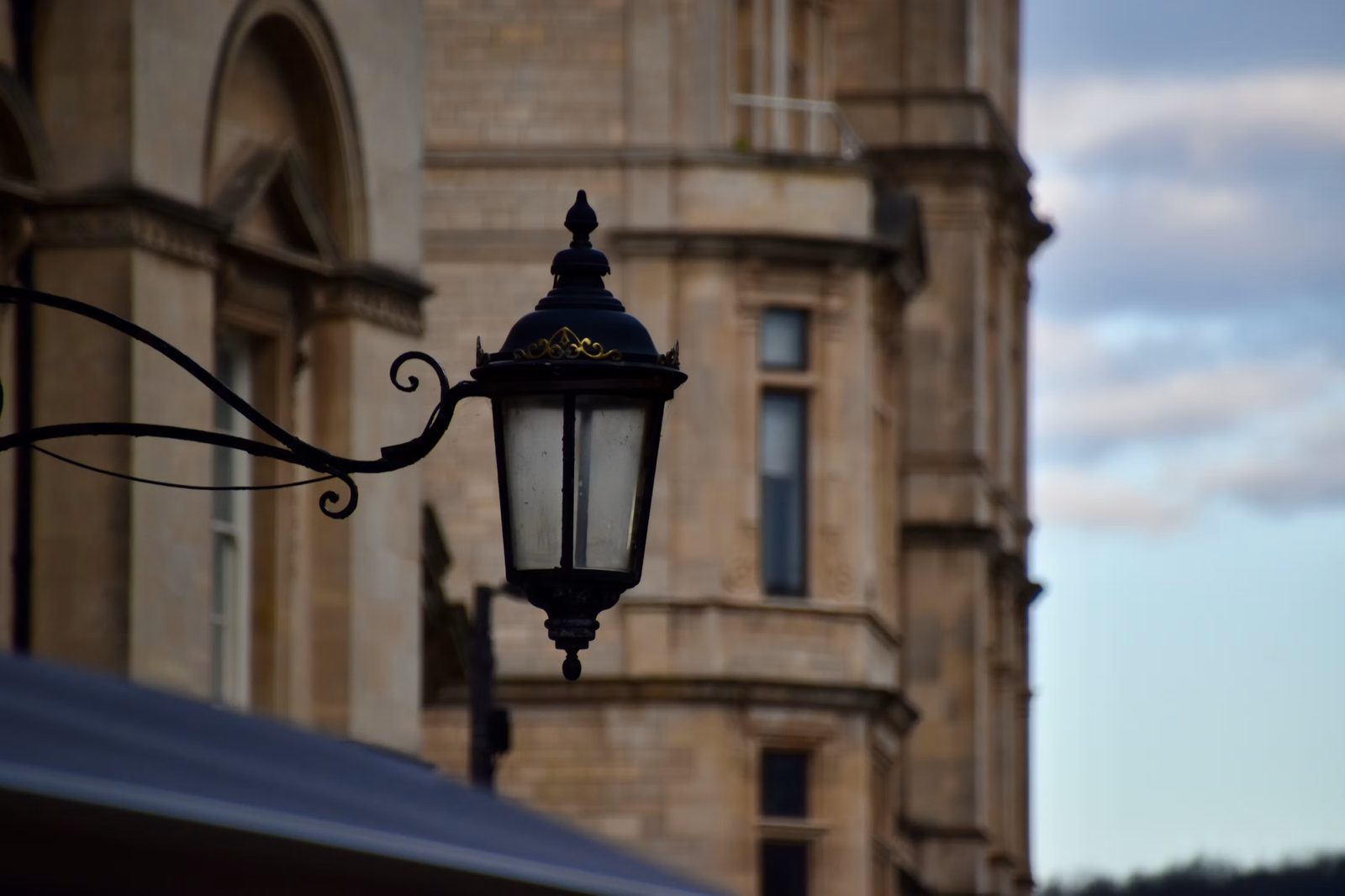 Historic City of London street lamp against stone facades