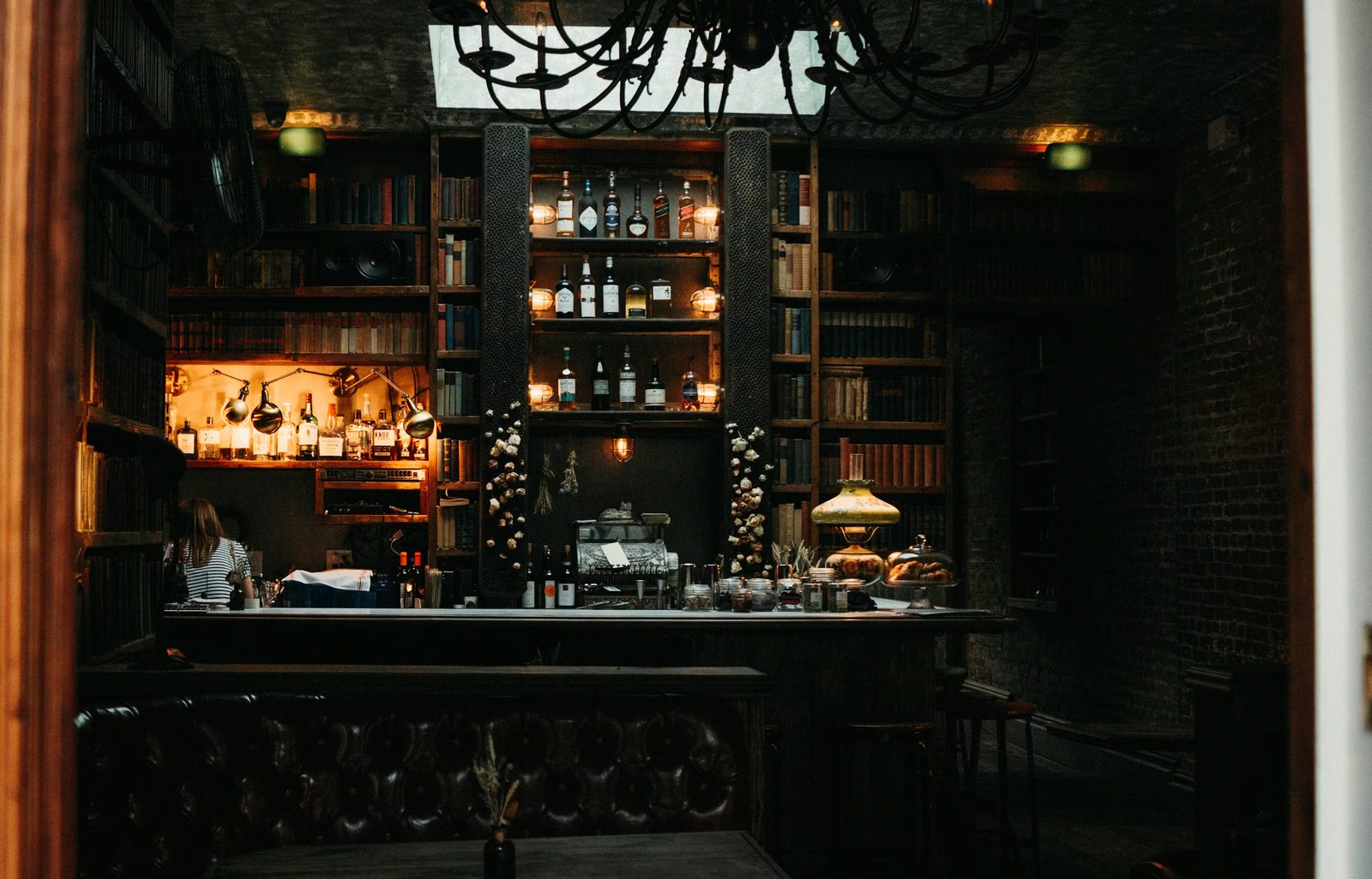 The bar at The Gracechurch, backlit shelves and a brass rail